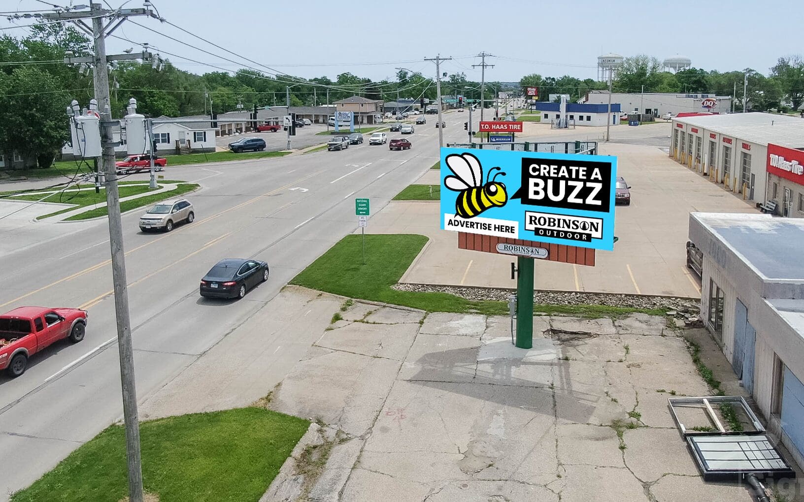 A busy intersection with cars driving down the road.