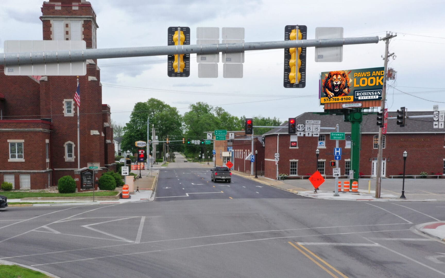 A street with traffic lights and construction signs.