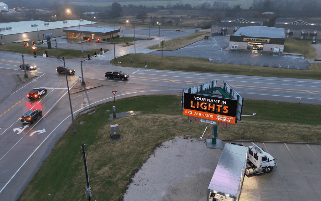 Intersection with digital billboard and vehicles.