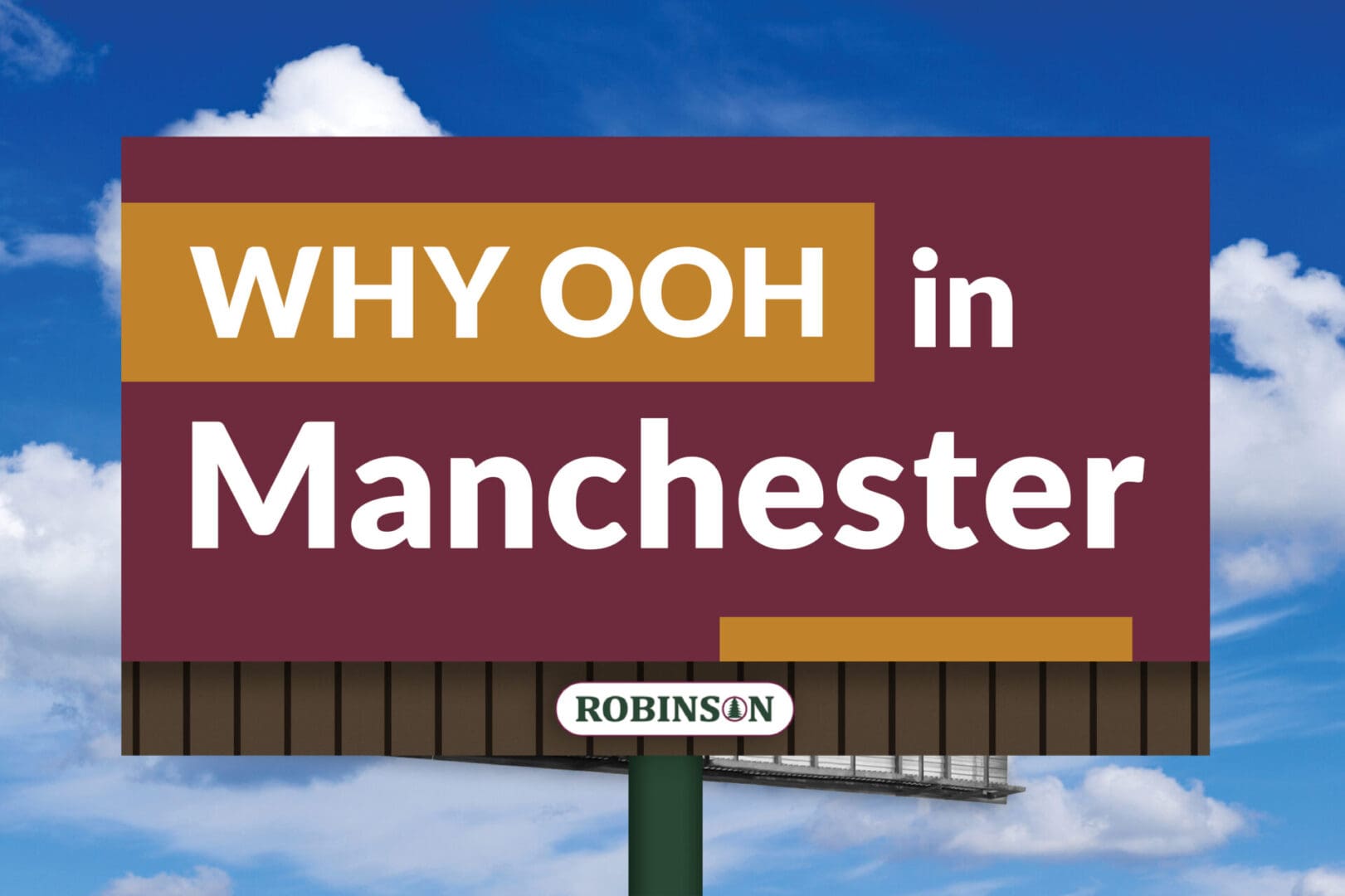 Billboard promoting OOH advertising in Manchester against a blue sky.